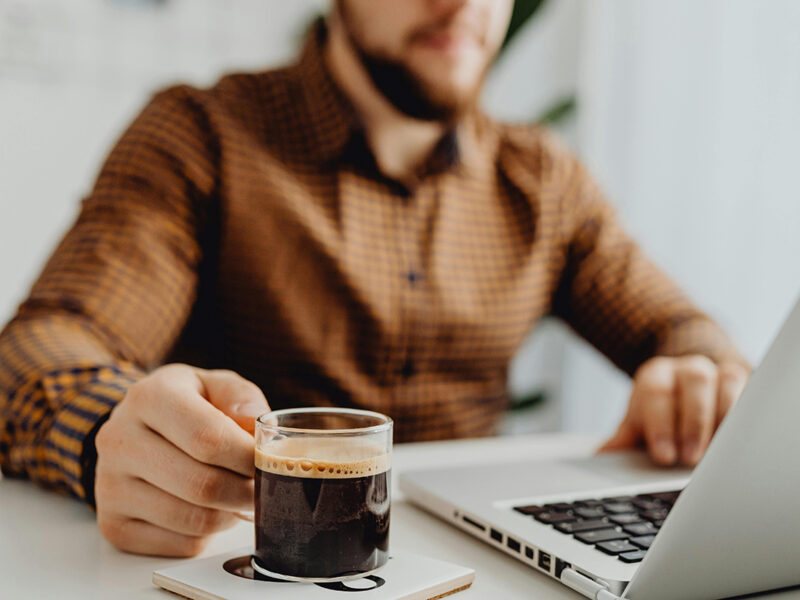 Designated fundholder with coffee and a laptop